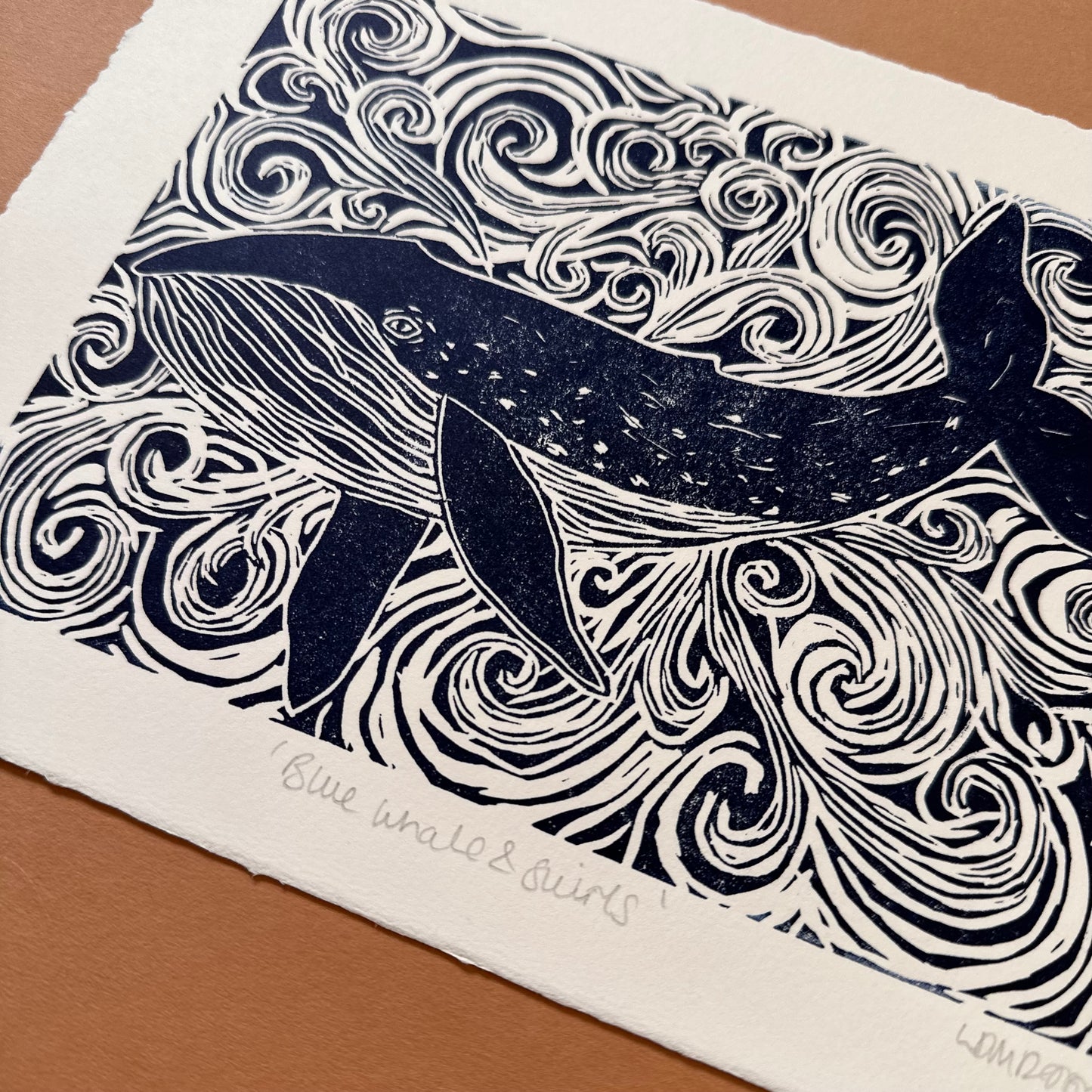 Original Linocut print of ‘Blue Whale & swirls’.