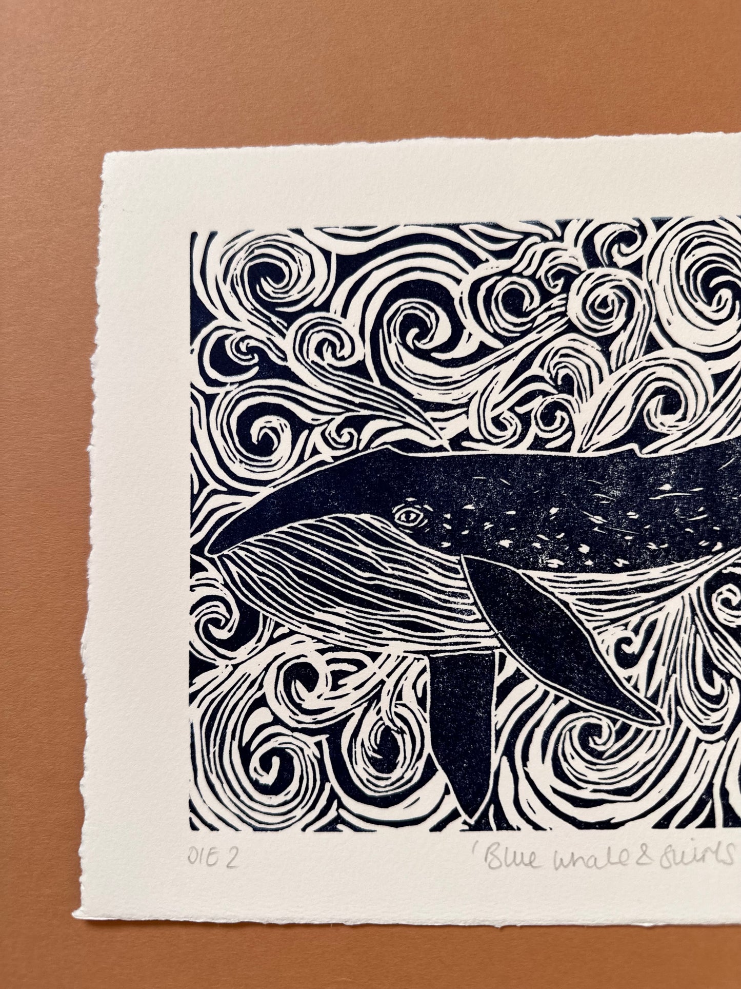 Original Linocut print of ‘Blue Whale & swirls’.